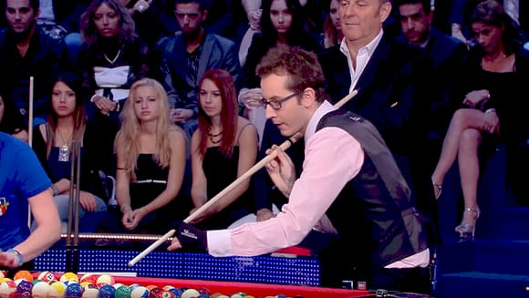 Гравець забиває кулі в більярді